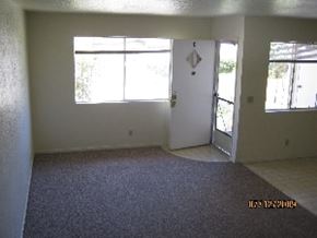 Grover Beach apartment for rent - A room with a carpeted floor and a white door.