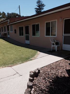 Arroyo Grande apartment for rent - A pink house with a white chair in front.