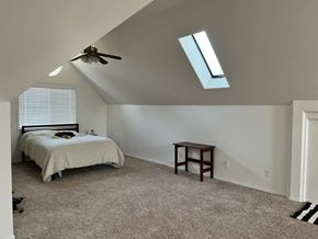 Arroyo Grande apartment for rent - A bedroom with a bed, a table, and a ceiling fan.