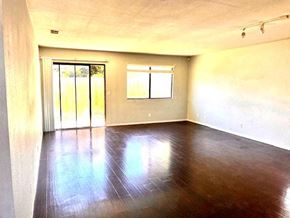Grover Beach house for rent - Empty room with wooden floor and sliding glass door.