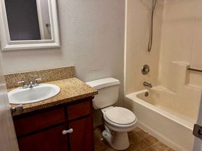 Grover Beach house for rent - A white toilet sits next to a sink in a bathroom.