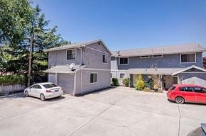 Atascadero apartment for rent - A white car is parked in a driveway in front of a grey house.