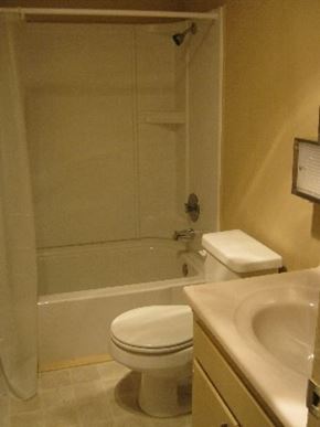 Arroyo Grande apartment for rent - A white toilet sits next to a sink in a bathroom.