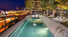 Plano apartment for rent - Resort-inspired pool courtyard with sunbathing shelves, fire pits, and grilling areas