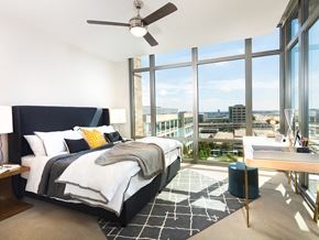 Plano apartment for rent - a bedroom with a bed and a view of the city