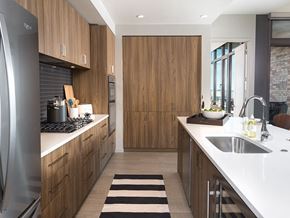 Plano apartment for rent - a kitchen with wooden cabinets and white counter tops