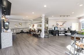 Covington apartment for rent - a communal room with tables and chairs and a kitchen and a tv
