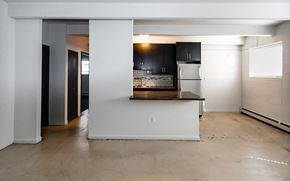 Denver apartment for rent - A kitchen with a refrigerator, sink, and cabinets is shown.