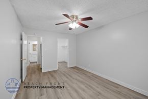 Downey apartment for rent - a living room with a ceiling fan and white walls