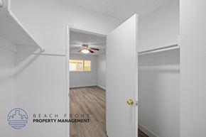 Downey apartment for rent - a bedroom with white walls and a ceiling fan