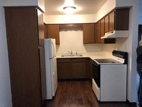 Island Lake apartment for rent - a small kitchen with a white refrigerator and a sink