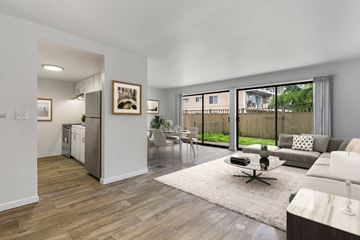 Burien apartment for rent - A modern living room with a white couch and a coffee table.