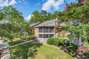 Durham apartment for rent - a house with a yard and trees and a bench