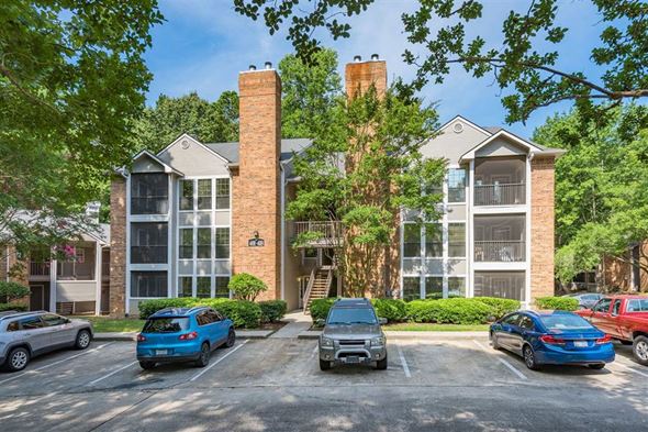 Durham apartment for rent - an apartment building with cars parked in a parking lot