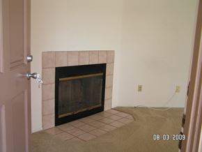 San Diego apartment for rent - A fireplace in a room with a door on the left.