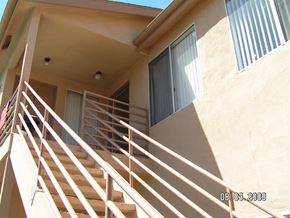 San Diego apartment for rent - A staircase with a railing leads to a door.