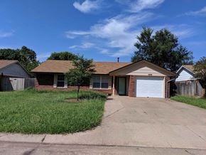 Stillwater house for rent - A house with a brown roof and a white garage door.