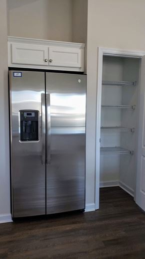 Harlem apartment for rent - a stainless steel refrigerator freezer sitting inside of a closet