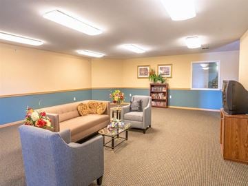 Milwaukee apartment for rent - a living room with couches and chairs and a television
