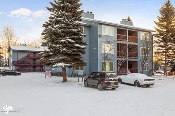 Anchorage apartment for rent - a car parked in the snow in front of a building