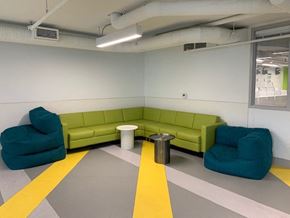 Vancouver apartment for rent - a living room with a green couch and two blue chairs