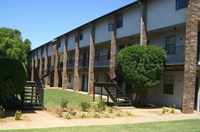 Stillwater apartment for rent - an exterior view of a building with stairs and balconies