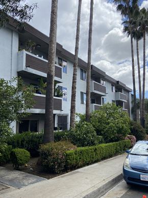 West Hollywood apartment for rent - an apartment building on a street with palm trees