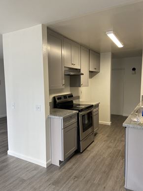West Hollywood apartment for rent - an empty kitchen with stainless steel appliances and white cabinets
