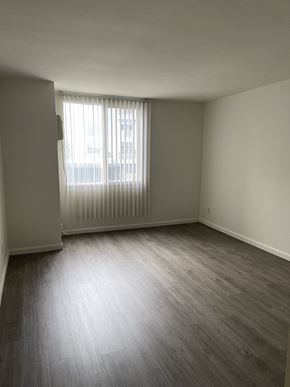 West Hollywood apartment for rent - an empty living room with wood floors and a window