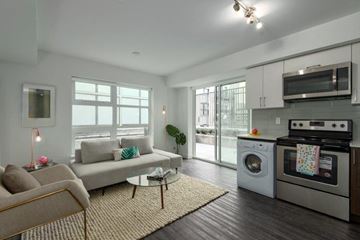 Vancouver apartment for rent - a living room with a couch and a washing machine