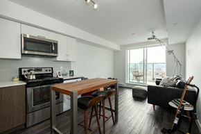 Vancouver apartment for rent - a kitchen and living room with a wooden table