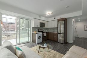 Vancouver apartment for rent - a living room with a kitchen and a couch