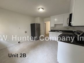 Wilson apartment for rent - A kitchen area with a refrigerator, microwave, and oven.