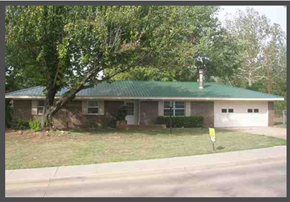 Stillwater house for rent - a house with a green roof and a tree
