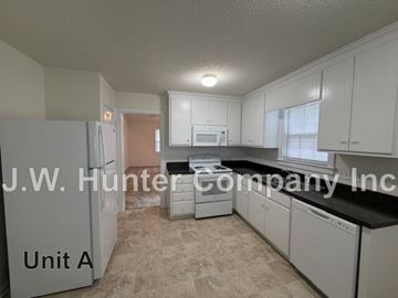 Wilson apartment for rent - A kitchen with white cabinets and appliances is labeled "Unit A".