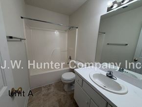 Wilson apartment for rent - A bathroom with a toilet, sink, and shower.