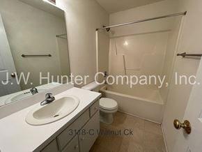 Wilson apartment for rent - A bathroom with a sink, toilet, and bathtub.