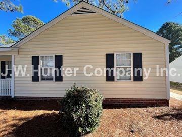 Wilson apartment for rent - A small house with a sign that says J.W. Hunter Company Inc. on it.