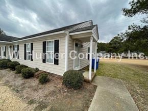 Wilson apartment for rent - A mobile home with a white porch and black shutters.