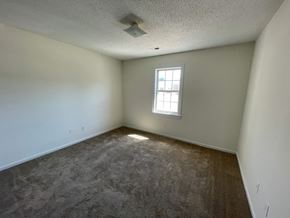 Wilson apartment for rent - A room with a window and carpeted floor.