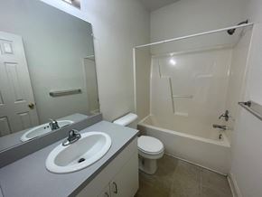 Wilson apartment for rent - A white bathroom with a sink, toilet and bathtub.