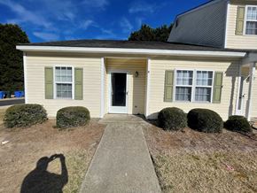 Wilson apartment for rent - A house with a white door and green shutters.