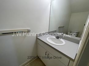 Wilson apartment for rent - A white bathroom sink with a mirror above it.