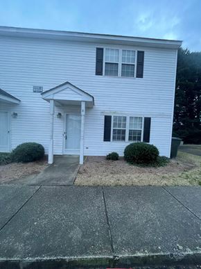 Wilson apartment for rent - A white house with a black door and windows.
