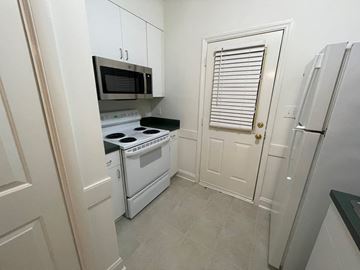 Wilson apartment for rent - A small kitchen with a white oven and microwave.