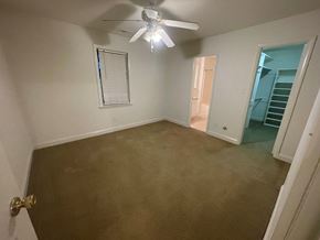 Wilson apartment for rent - A room with a ceiling fan and carpeted floor.