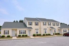 Wilson apartment for rent - a large house with a red car parked in front of it