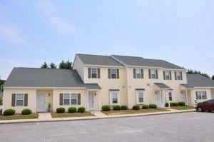 Wilson apartment for rent - a large house with a red car parked in front of it