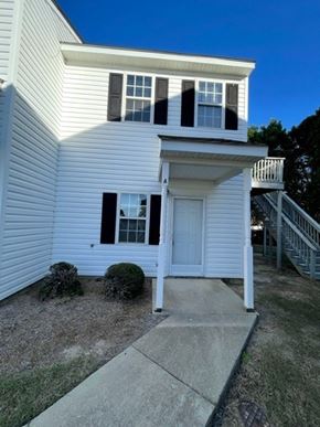Wilson apartment for rent - A white house with a porch and a small front yard.