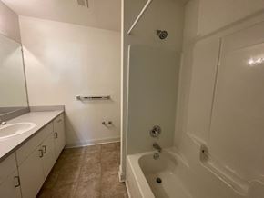 Wilson apartment for rent - A white bathroom with a tub and sink.